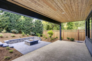 New modern Massachusetts home features a backyard with patio